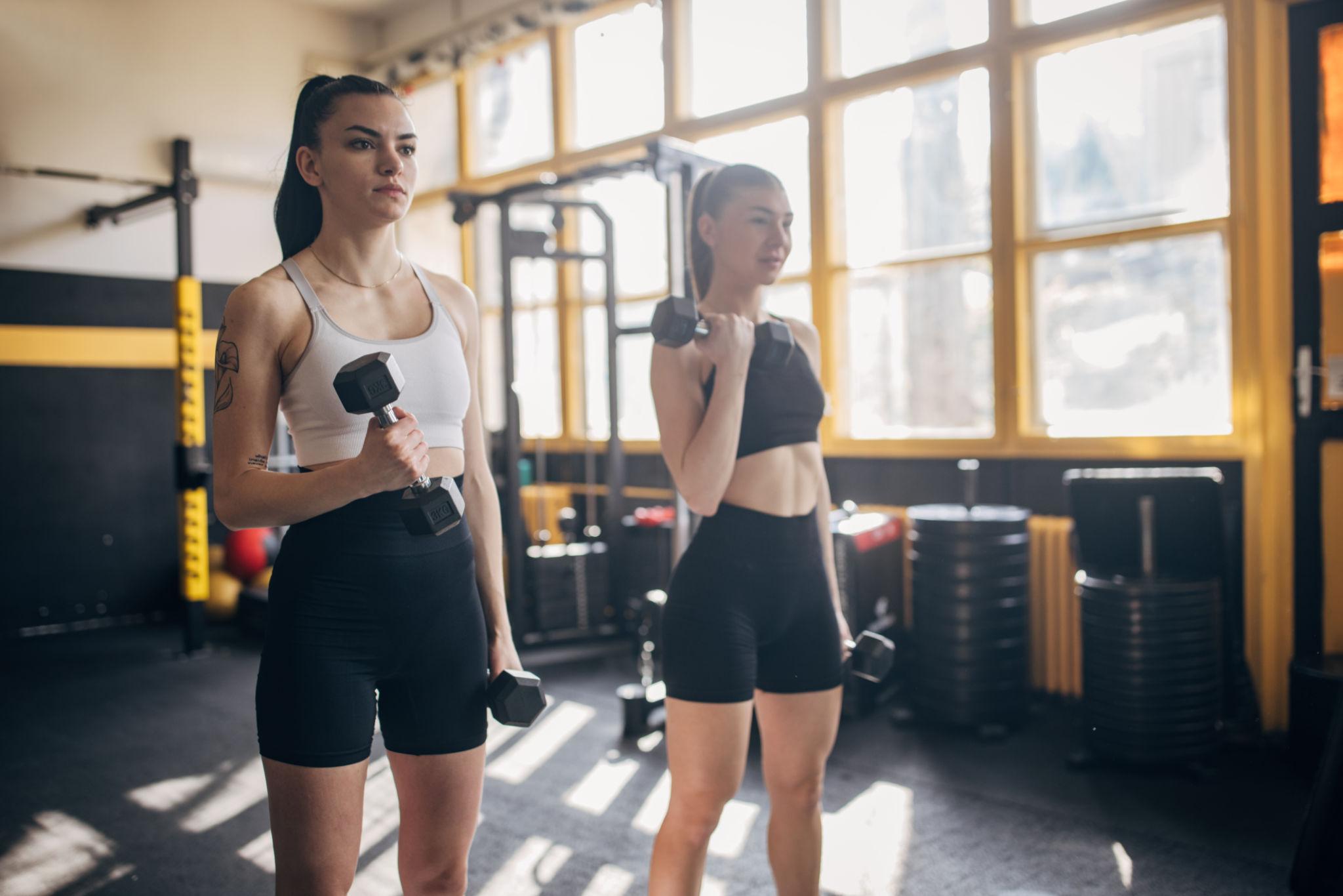 busy mom doing quick fitness workout at home with dumbbells
