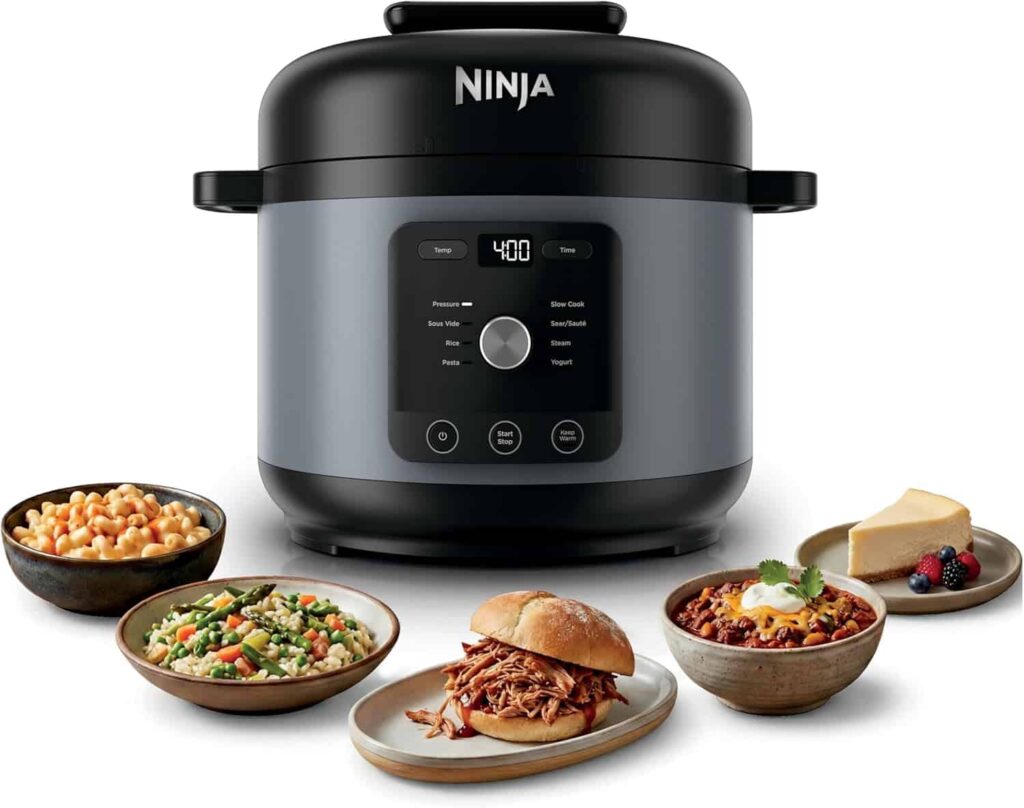 Electric pressure cooker for fast family meals with prepared dishes displayed beside the cooker