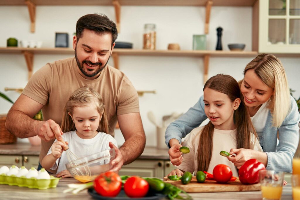 Happy family cooking healthy budget meals together in kitchen.