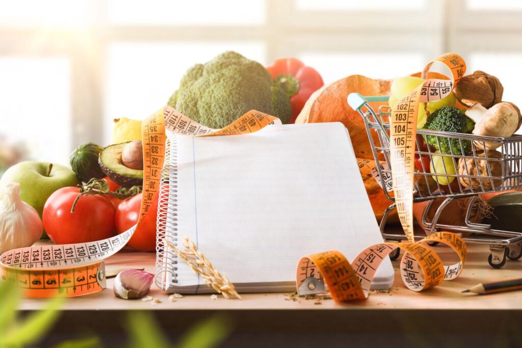 Meal planner notebook with grocery list for family budget meals.